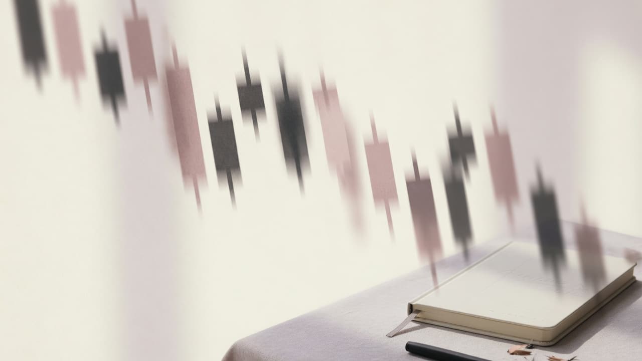 Soft abstract descending chart shapes on a cream backdrop with a minimal desk corner