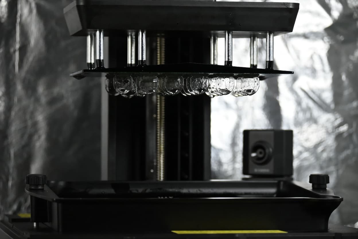 3D printer build plate with clear resin NBS nail covers mid-print
